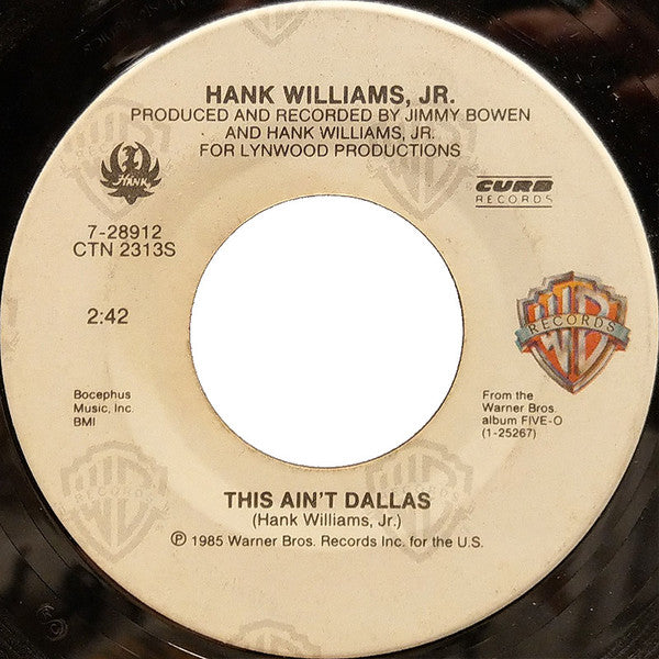 Hank Williams, Jr.* : This Ain't Dallas / I Really Like Girls (7", SRC)
